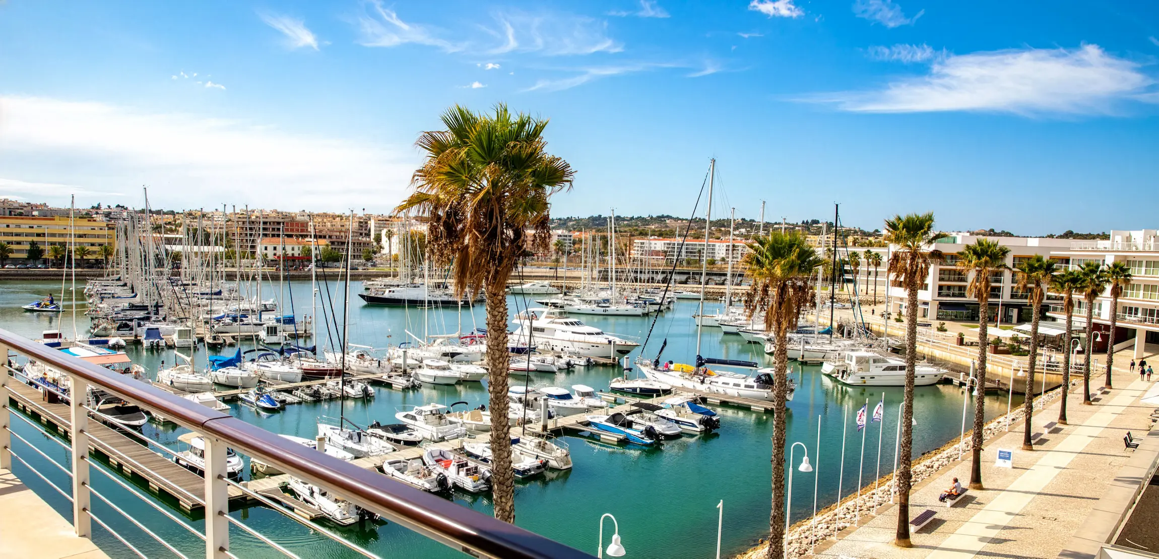 Lagos Marina in the Algarve surrounded by scenic coastline and sailing boats