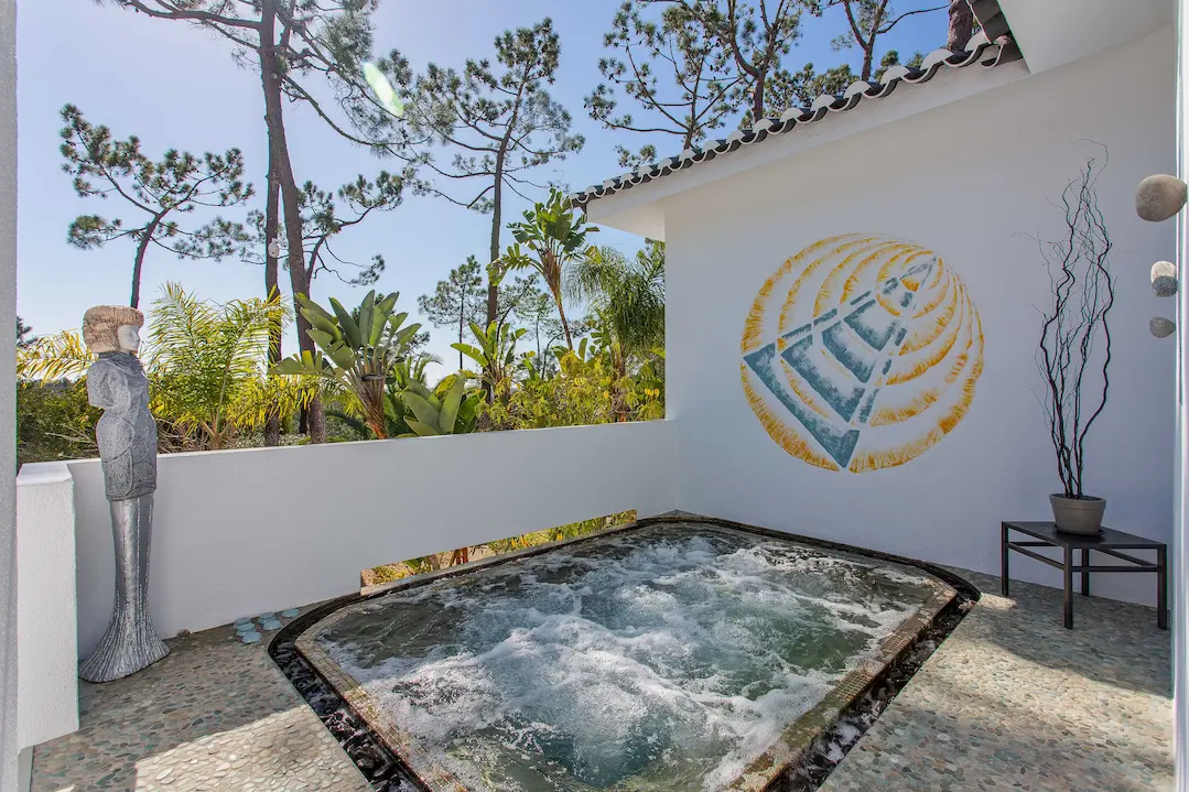 Private outdoor jacuzzi surrounded by gardens at Casa Estrela Algarve