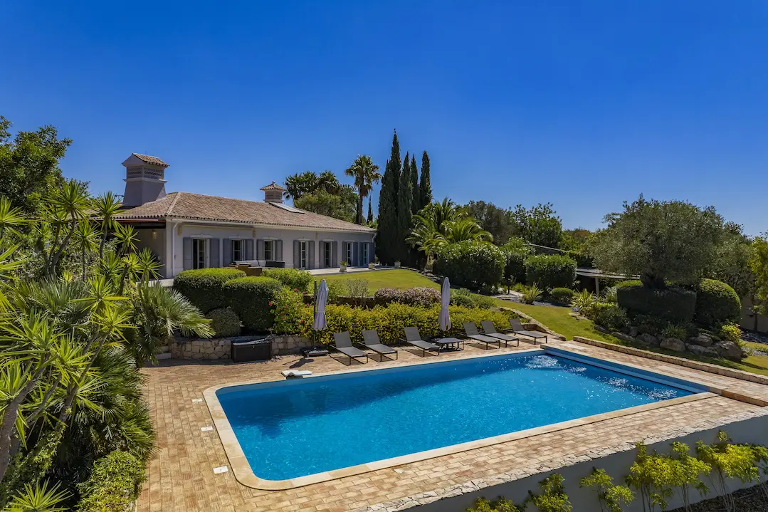 Panoramic exterior of Villa Alegria showcasing Algarve hills and distant sea horizon